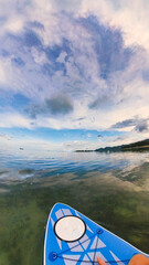 Paddle board on quiet waters on a sunset cloudscape before the storm in Chaweng Beach, Ko Samui