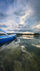 Paddle board on quiet waters on a sunset cloudscape before the storm in Chaweng Beach, Ko Samui