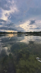 Stormy cloudscape seascape water edge on the shore of an ocean in a tropical Thailand beach