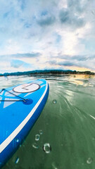 Paddle board on quiet waters on a sunset cloudscape before the storm in Chaweng Beach, Ko Samui