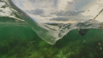 Beautiful transparent water landscape on a point of view just over the surface on a quiet beach sunset cloudscape in Chaweng, Ko Samui, Thailand