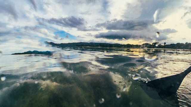 Stormy cloudscape seascape water edge on the shore of an ocean in a tropical Thailand beach