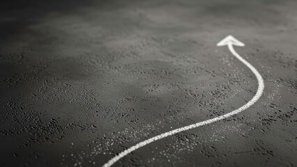 White chalk arrow pointing up on a dark grey background, growth concept.