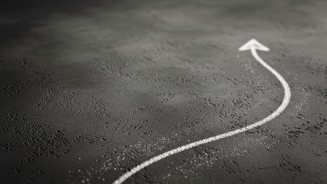 White chalk arrow pointing up on a dark grey background, growth concept. - Powered by Adobe