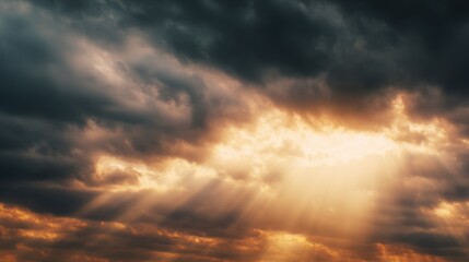Obraz premium Clouds parting to reveal bright sunlight in a dramatic evening sky