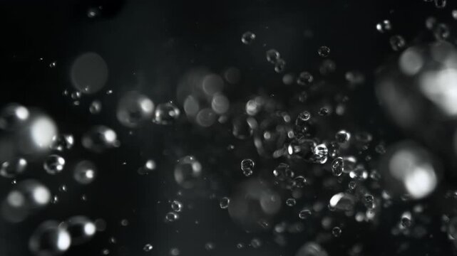 Super Slow Motion Shot of Falling Water Drops on Black Background at 1000fps.