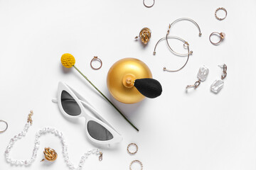 Composition with stylish female accessories and bottle of perfume on grey background