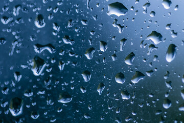 Rainy days, rain drops on the window. Selective focu son rain drops with blurred background.