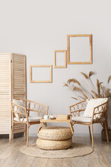 Chairs, coffee table, folding screen and pampas grass in interior of living room