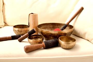 Bronze Tibetan singing bowls with a stick. Sound therapy, meditation, spa.