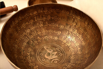 Bronze Tibetan singing bowl with a stick. Sound therapy, meditation, spa.