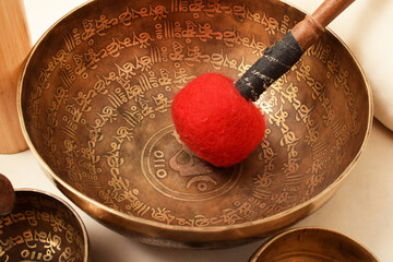 Bronze Tibetan singing bowl with a stick. Sound therapy, meditation, spa.
