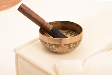 Bronze Tibetan singing bowl with a stick. Sound therapy, meditation, spa.