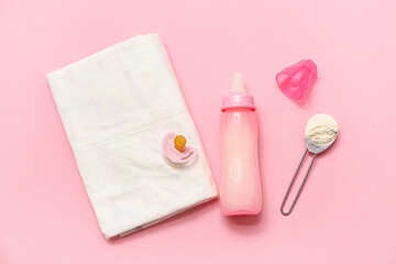 Bottle of milk for baby, pacifier and diaper on pink background
