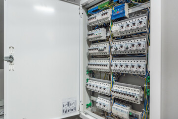 A detailed view of an electrical panel located in a residential building, displaying many circuit...
