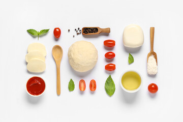 Raw dough and ingredients for preparing pizza with mozzarella on white background