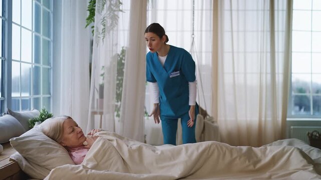 Rude nurse shouting at old woman patient lying in bed, unprofessional conduct