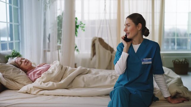 Nurse neglecting senior female patient in bed while talking on phone, disrespect