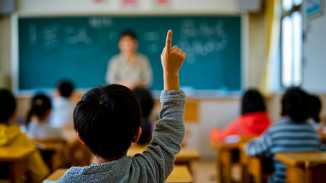 A child in a classroom raises their hand to answer a question