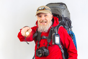 A cheerful bearded hiker in a red jacket points forward, wearing a headlamp and cap. He carries a large backpack with a camera and rope, ready for an outdoor adventure against a plain background.