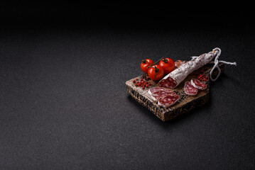 Dry Spanish salami sausage fuet as a snack for the dinner table. Fuet sausage