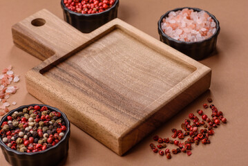 Wood, a wooden empty cutting board on a dark kitchen table. Wooden cutting board