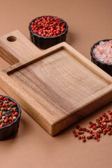 Wood, a wooden empty cutting board on a dark kitchen table. Wooden cutting board