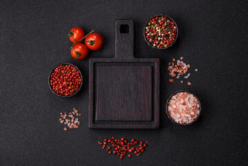 Wood, a wooden empty cutting board on a dark kitchen table. Wooden cutting board