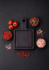 Wood, a wooden empty cutting board on a dark kitchen table. Wooden cutting board