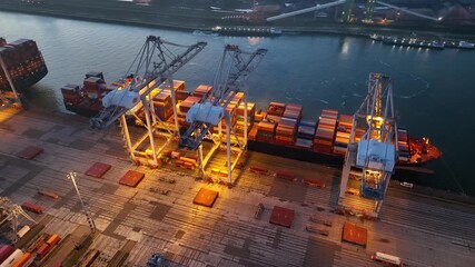 Rotterdam, Netherlands, Drone shot of modern industrial port with containers between night and sunrise. Panorama over sunset. It is an import and export cargo port where is a part of shipping dock - Powered by Adobe