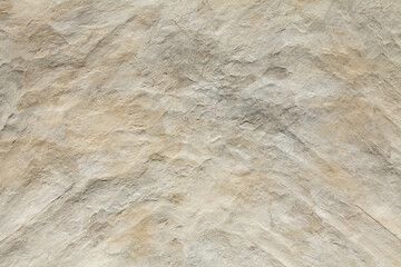 White, yellowed uneven (relief) surface. Chalked surface, background, texture. Clay bumpy surface, covered with lime or chalk. Old natural ecological coating in residential construction. Natural cover