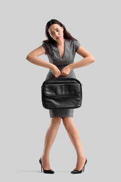 Businesswoman in pose of marionette on light background