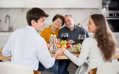 Happy family having dinner together at the festive table at home