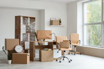Wrapped furniture with moving boxes in office