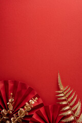 A vertical festive red backdrop showcases a folded paper fan design and gold fern accents, conveying a warm Chinese New Year greeting ideal for holiday decor and cultural celebrations