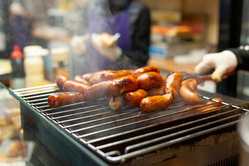 Grilled sausages on street food market