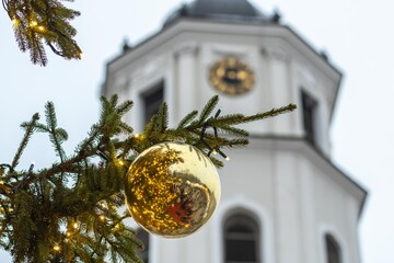 Detail of the Christmas tree with part of the tower bell in a festive city square in Vilnius, Lithuania, Europe