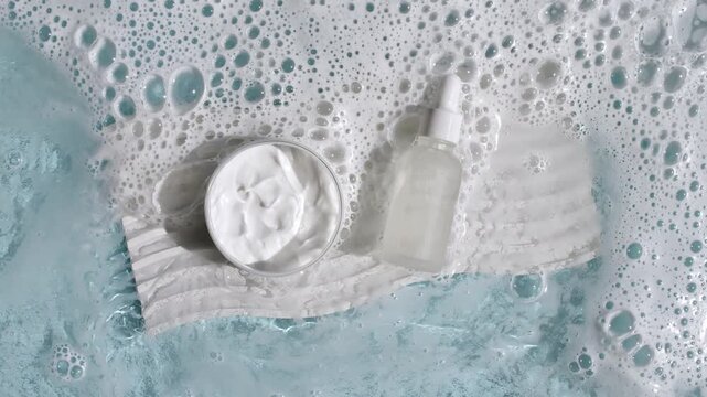 Bottle with a pipette for oil, toner, emulsion on water texture background surface with bubbles of white soapy foam. Women's cosmetics skincare, body care. Products advertisement spa, relaxation. 4k