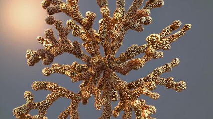 Glamorous golden christmas tree ornament encrusted with glitter slowly rotating against warm backlit gray, creating elegant bokeh, shimmer and festive holiday sparkle - Powered by Adobe