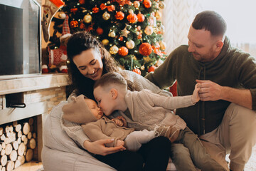 Family celebrating christmas holidays together with newborn baby