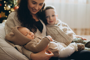 Family enjoying christmas with newborn baby and child