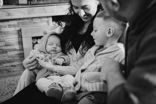 Family enjoying christmas with newborn sibling at home