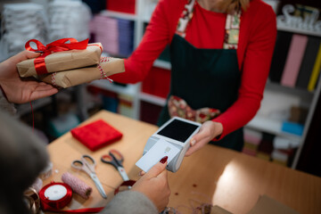 Customer buying christmas gifts using contactless payment