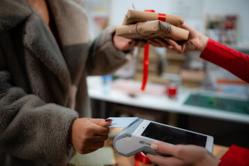 Customer purchasing gifts with credit card at retail store