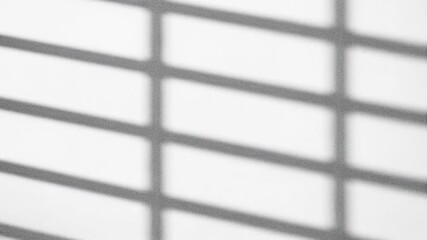 Abstract composition of light and shadows created by striped lines on a white surface.