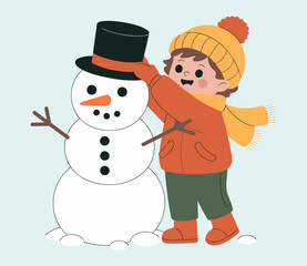 Happy Child in Winter Clothing Placing Hat on Snowman in Snowy Landscape