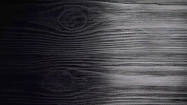 Close-up view of textured dark wood surface with visible grain patterns and striations.