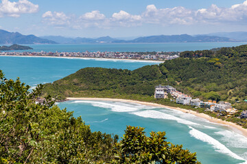 Quatro Ilhas beaches with buildings, mountains, forest and Mariscal beach in background