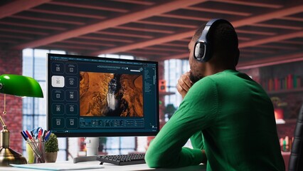 Digital editor uses AI powered text to video generator to create content, listening to music on headset. Internet connectivity and artificial intelligence tools on high tech software. Camera A.