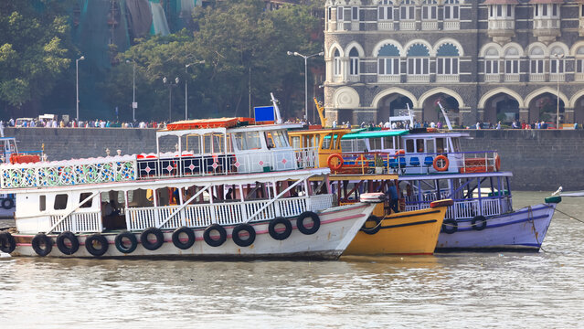Colorful traditional tour boats at the coast of Mumbai city near Gateway of India.